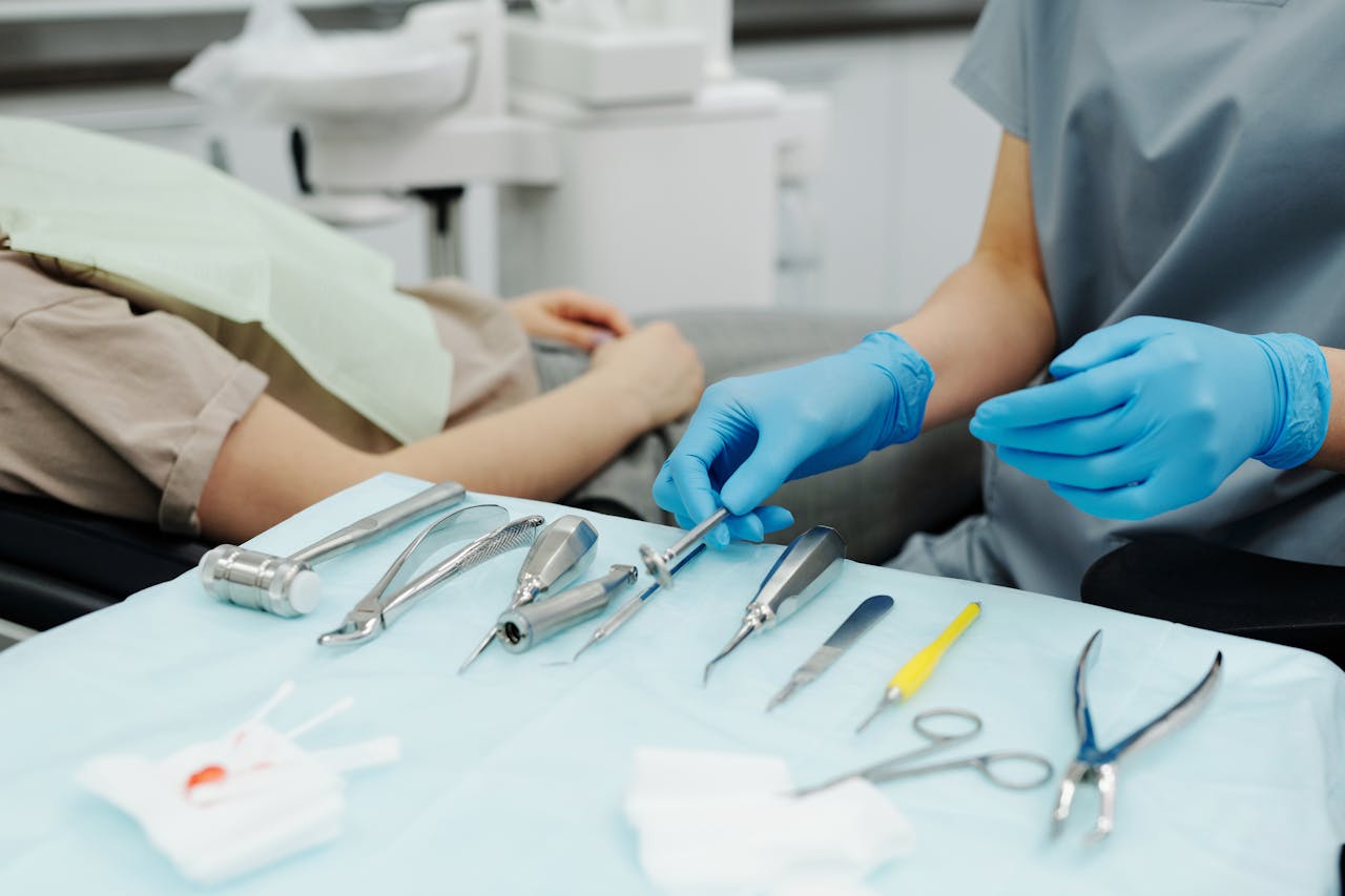about-us Dentist wearing gloves prepares tools for patient care in a modern clinic.